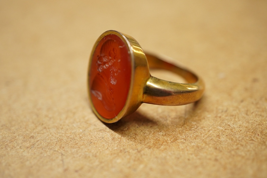 A yellow metal and intaglio carnelian set ring, the matrix carved with the bust of a gentleman to sinister, gross weigh 5.2 grams.